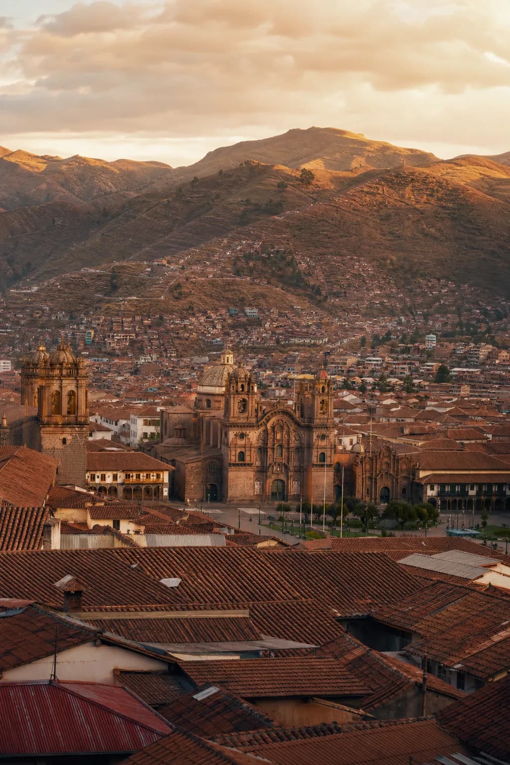 Historic Cusco rooftops and the Andes at golden hour